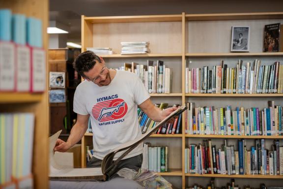 Man looking at an archival book