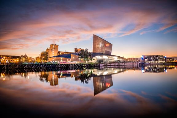Imperial War Museum North at sunset from across the Manchester Ship Canal