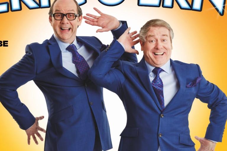 A poster featuring two comedians dressed as Morecambe and Wise