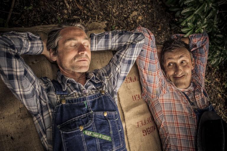 Two men lie on the ground