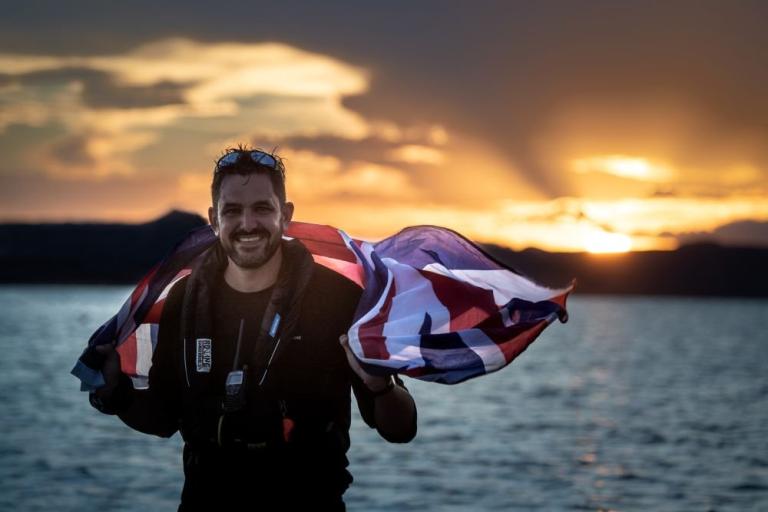 Jordan Wylie standing in front of the sea