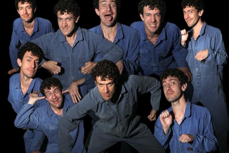 Guy Masterson performing as nine different people in a blue boilersuit
