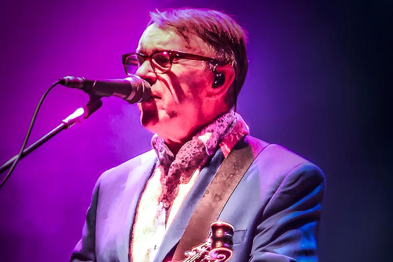 Chris Difford singing into a mic