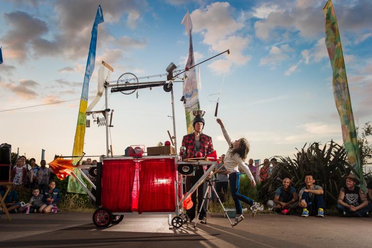 A child jumping up to try to reach a strange contraption