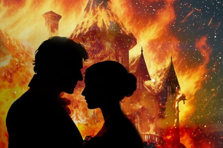 Two people silhouetted against a fire