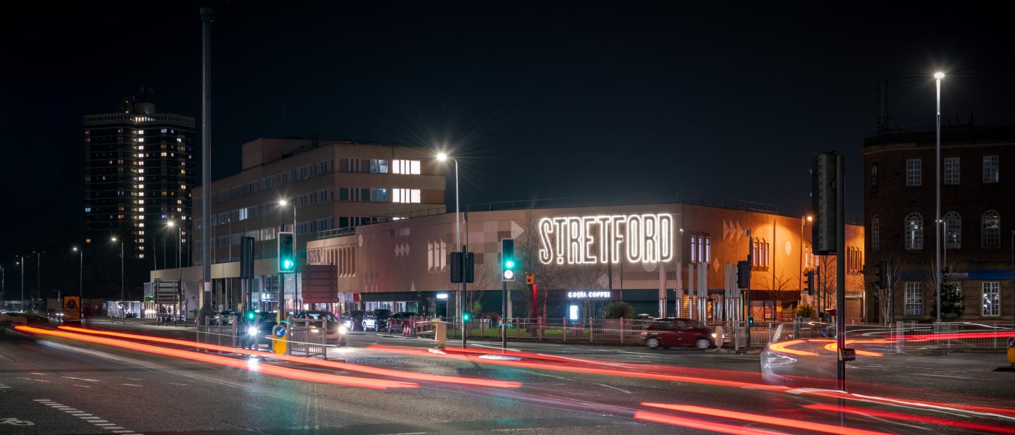 A long exposure night image of a busy road in Stretford
