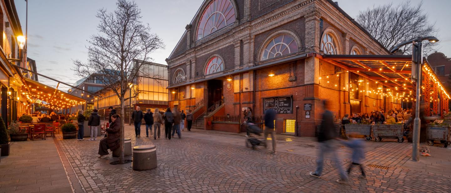 Altrincham Market in the evening people passing by