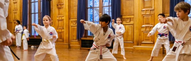 A group of children practicing Taekwondo