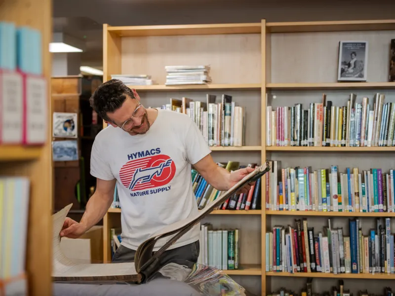 Man looking at an archival book