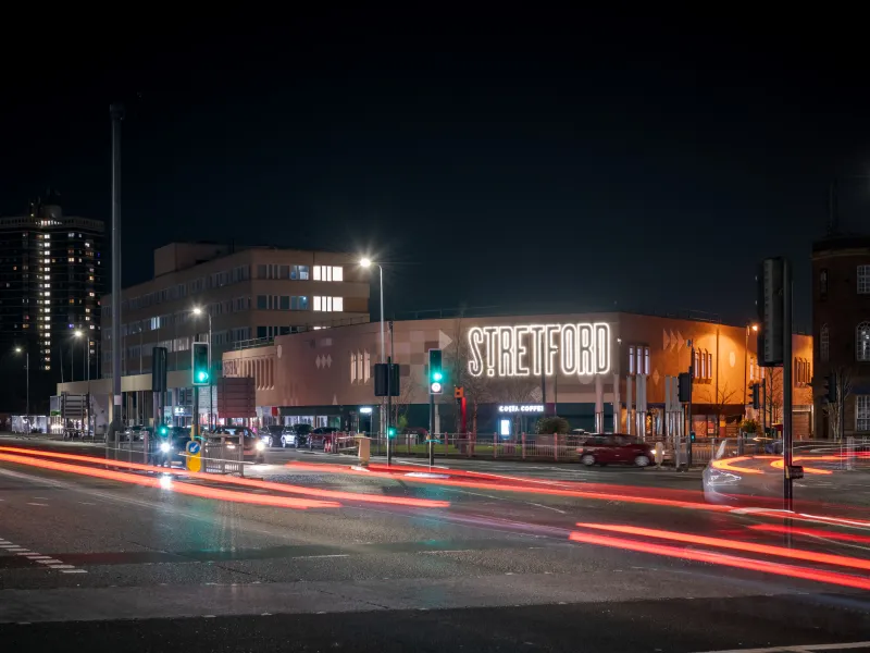 A long exposure night image of a busy road in Stretford