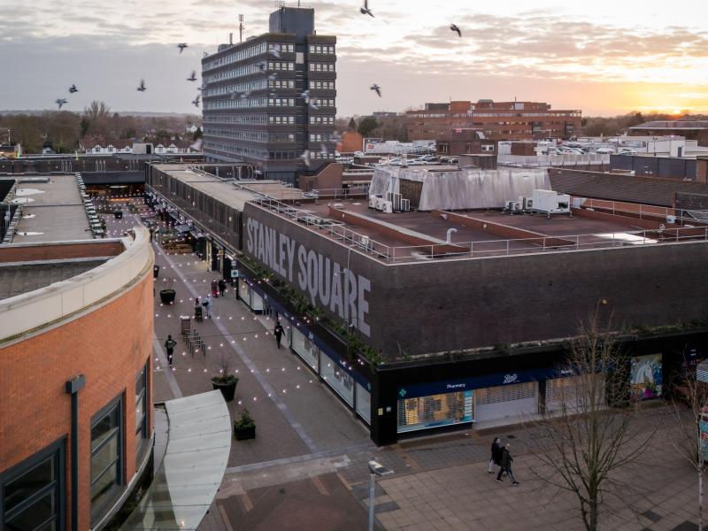Overlooking Stanley Square at sunset with pigeons in the sky