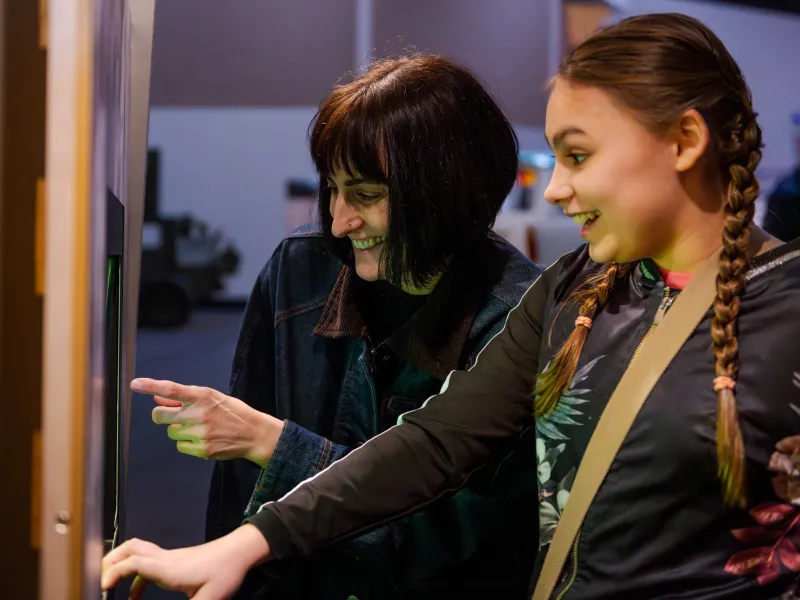 A woman and her daughter looking at an exhibition