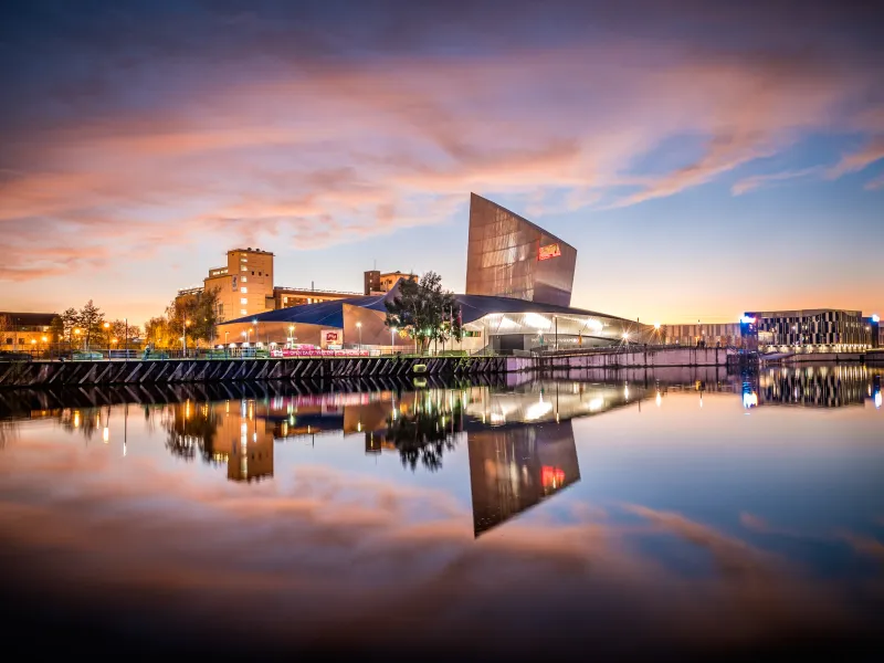 Imperial War Museum North at sunset from across the Manchester Ship Canal
