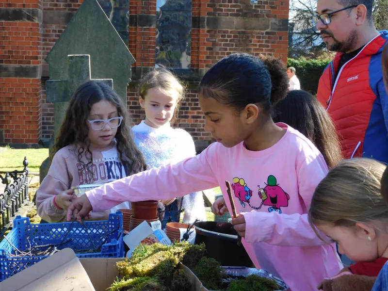 Children gathered around a craft table