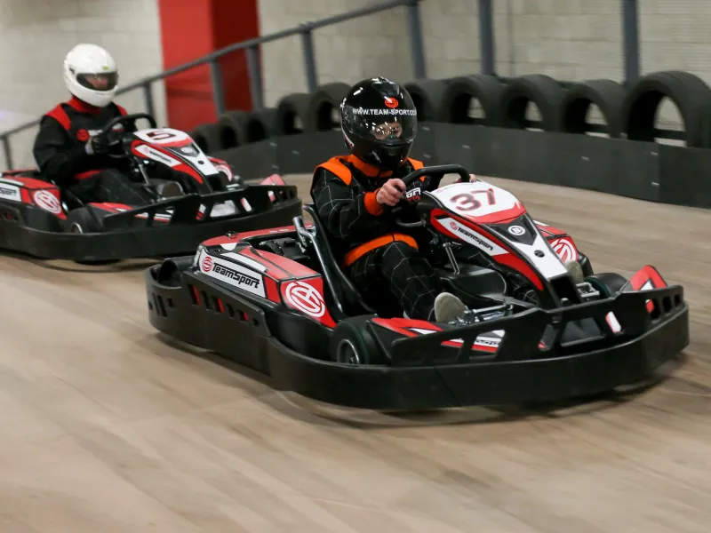 Two drivers on indoor karts at the TeamSport track