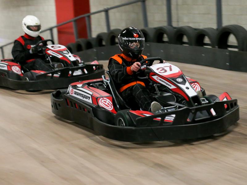 Two drivers on indoor karts at the TeamSport track