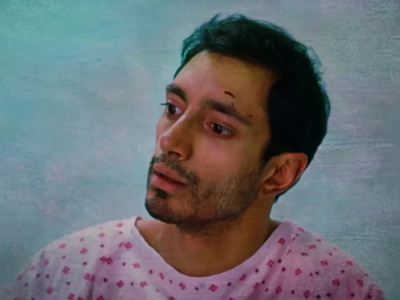 Photo of the actor Riz Ahmed in a pink t-shirt