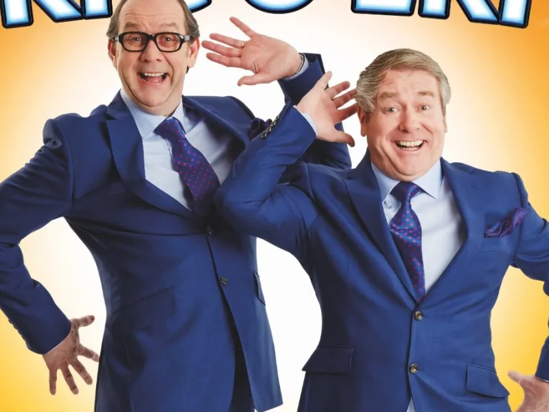 A poster featuring two comedians dressed as Morecambe and Wise
