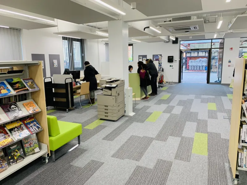 Internal library area showing bookshelves, library counter and entrance