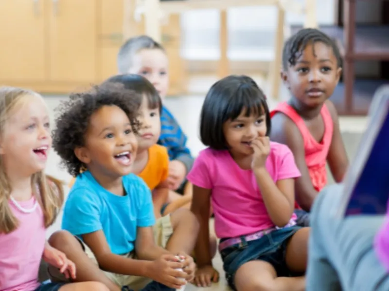 Group of children listening, laughing and having fun.