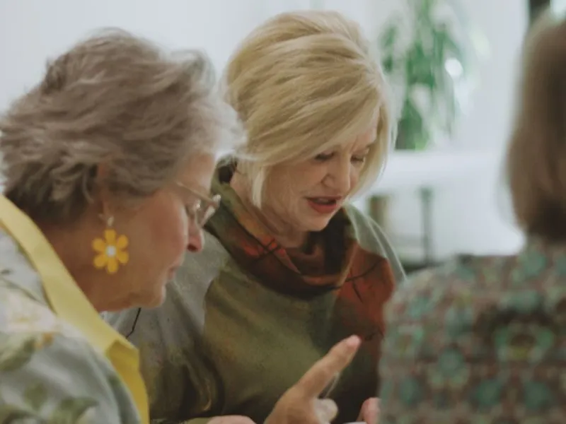 Women discussing a book