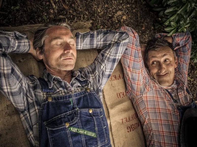 Two men lie on the ground