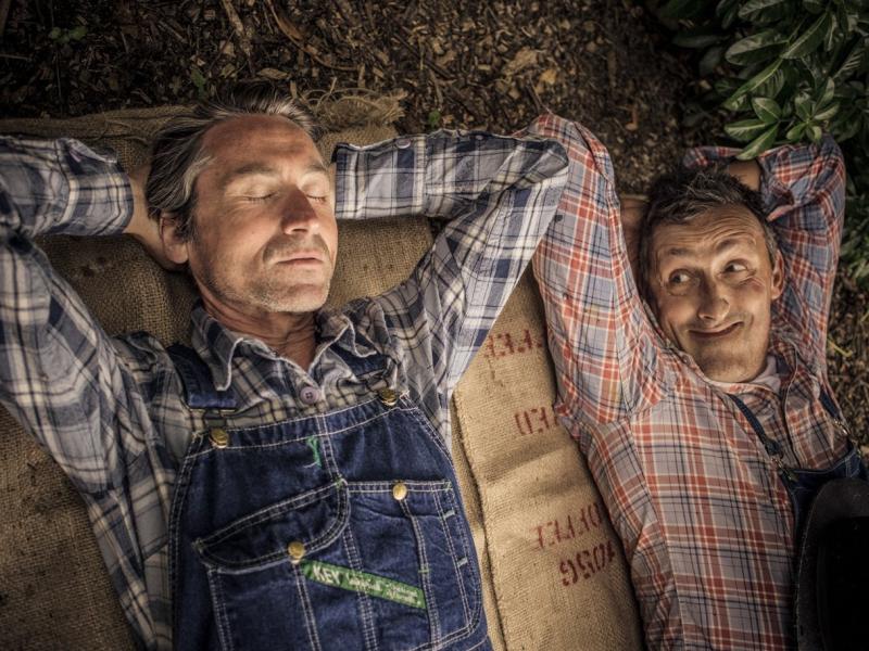 Two men lie on the ground