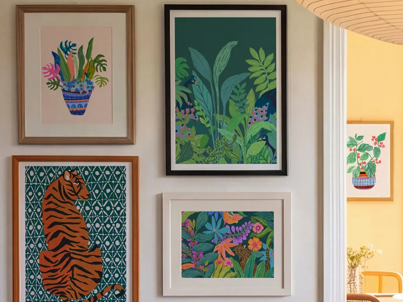 A wall featuring colourful prints by EllaJo Studio