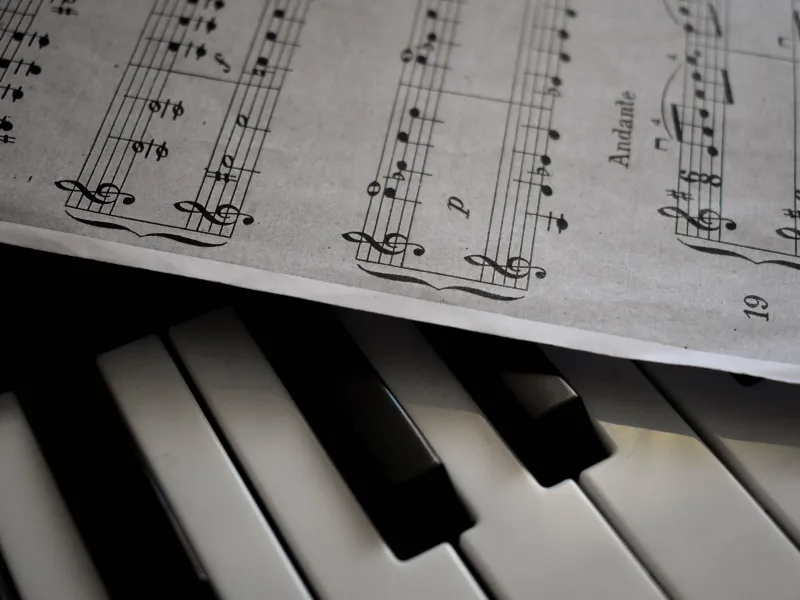Sheet music laying on top of a piano keyboard