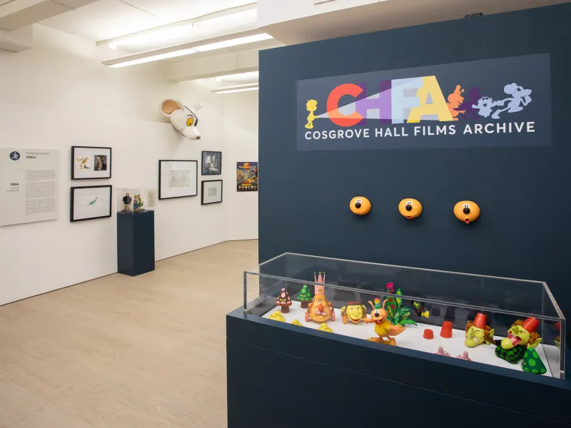 Exhibition space displaying artwork and models.