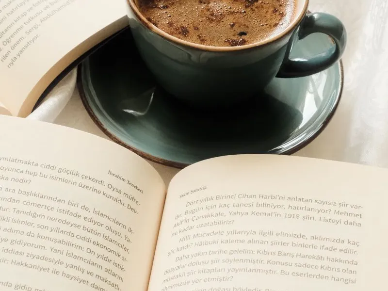 Cup of coffee and open books
