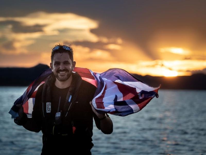 Jordan Wylie standing in front of the sea