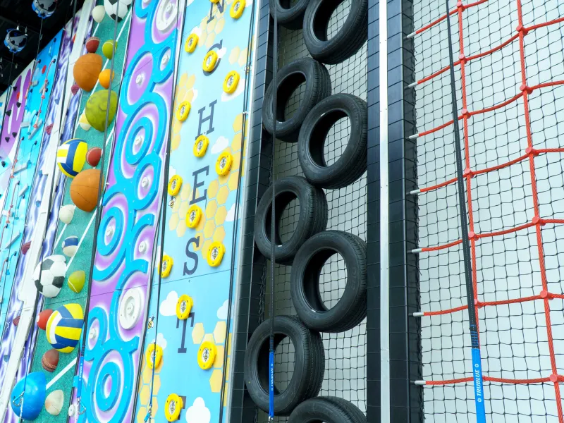 A climbing wall of various surfaces including ropes and tyres