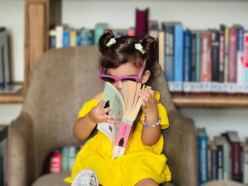 Little girl reading big book!