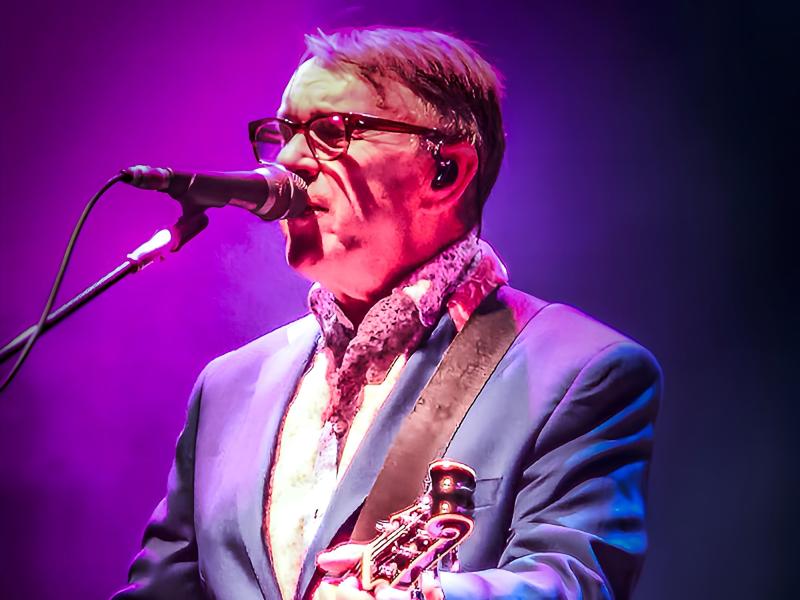 Chris Difford singing into a mic
