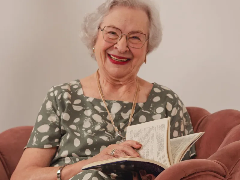 An older woman reading a book.