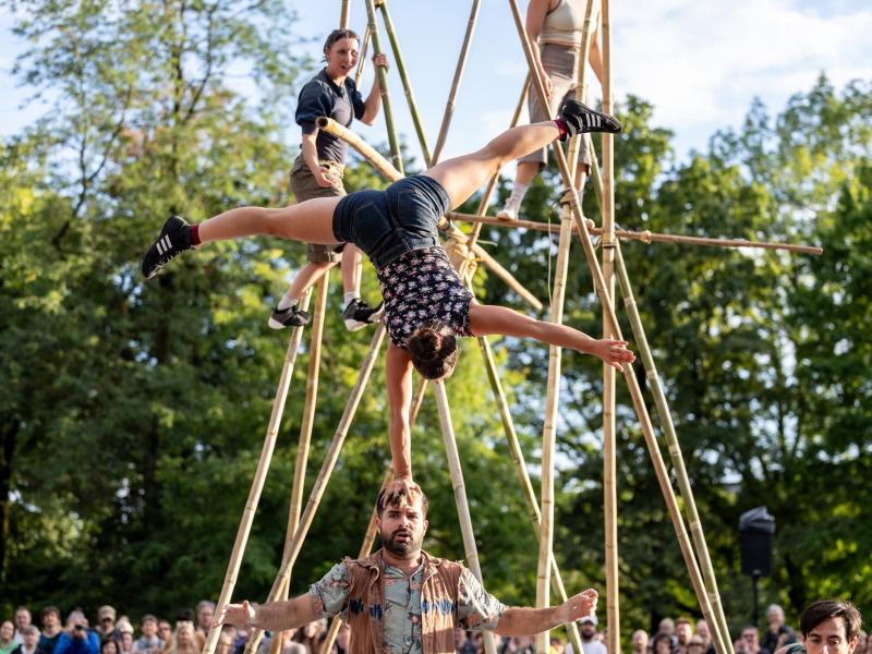Circus performers on long bamboo poles