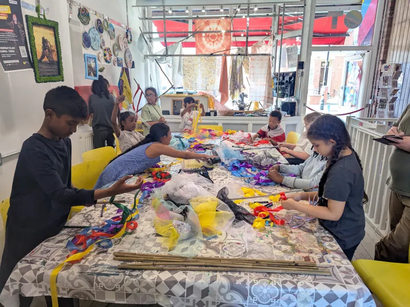 A group of children around a table getting creative 
