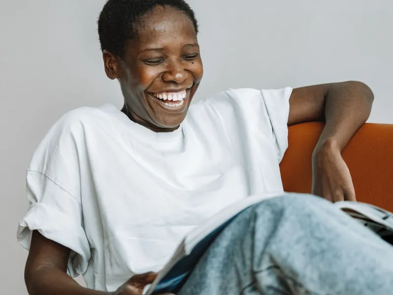 A woman reading and laughing.