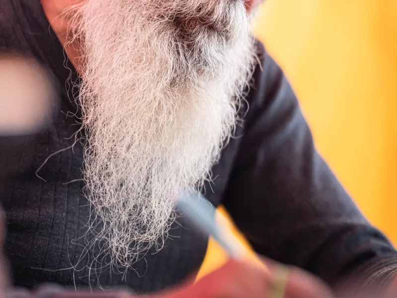 Bearded man writing.